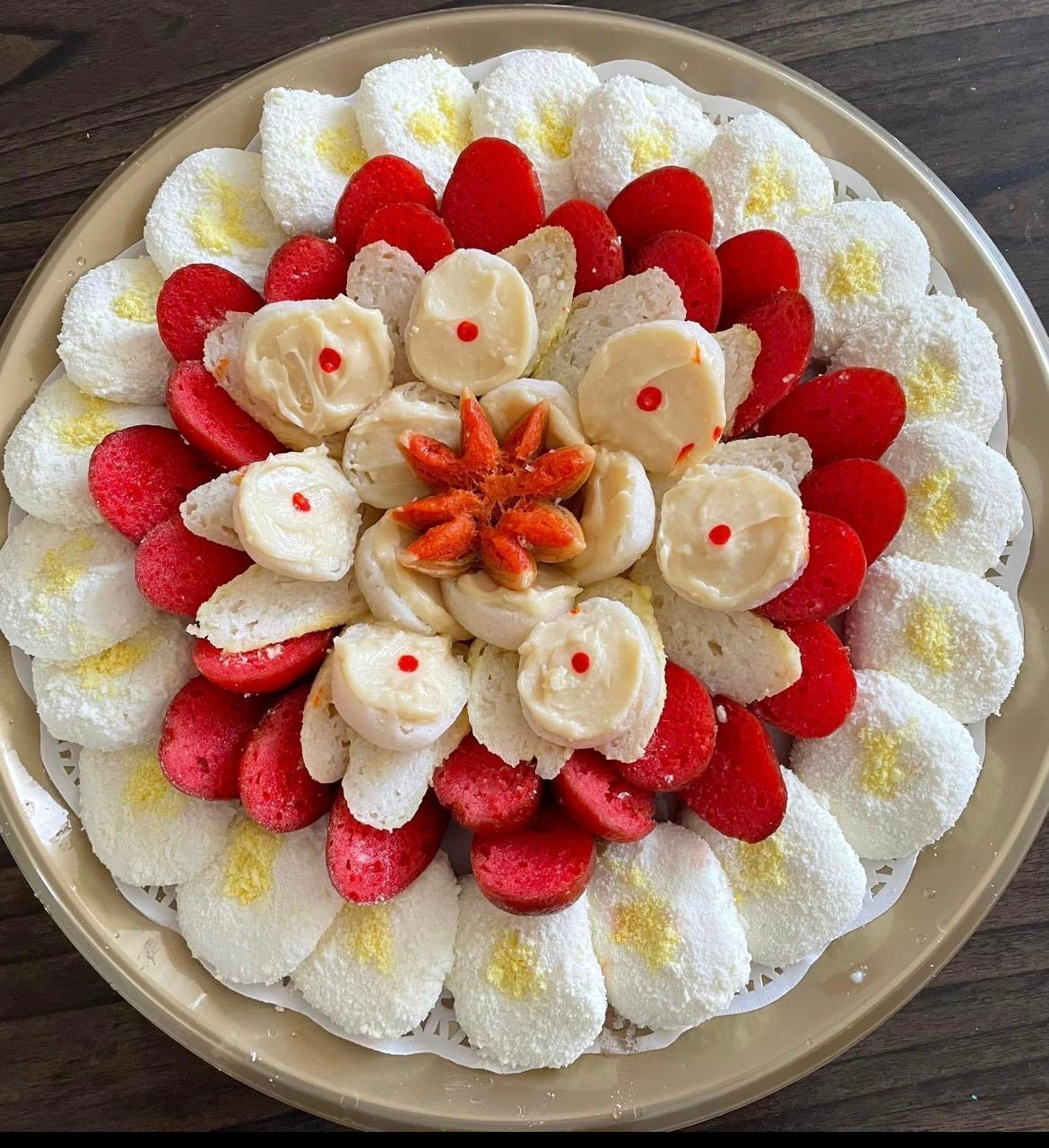 White and red sandesh platter with cream-filled centerpiece